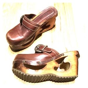 Brown slip on clogs with buckle strap